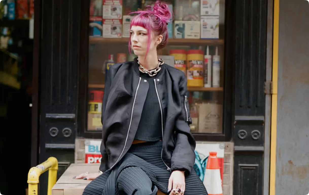 Philippa Price seated in front of a storefront