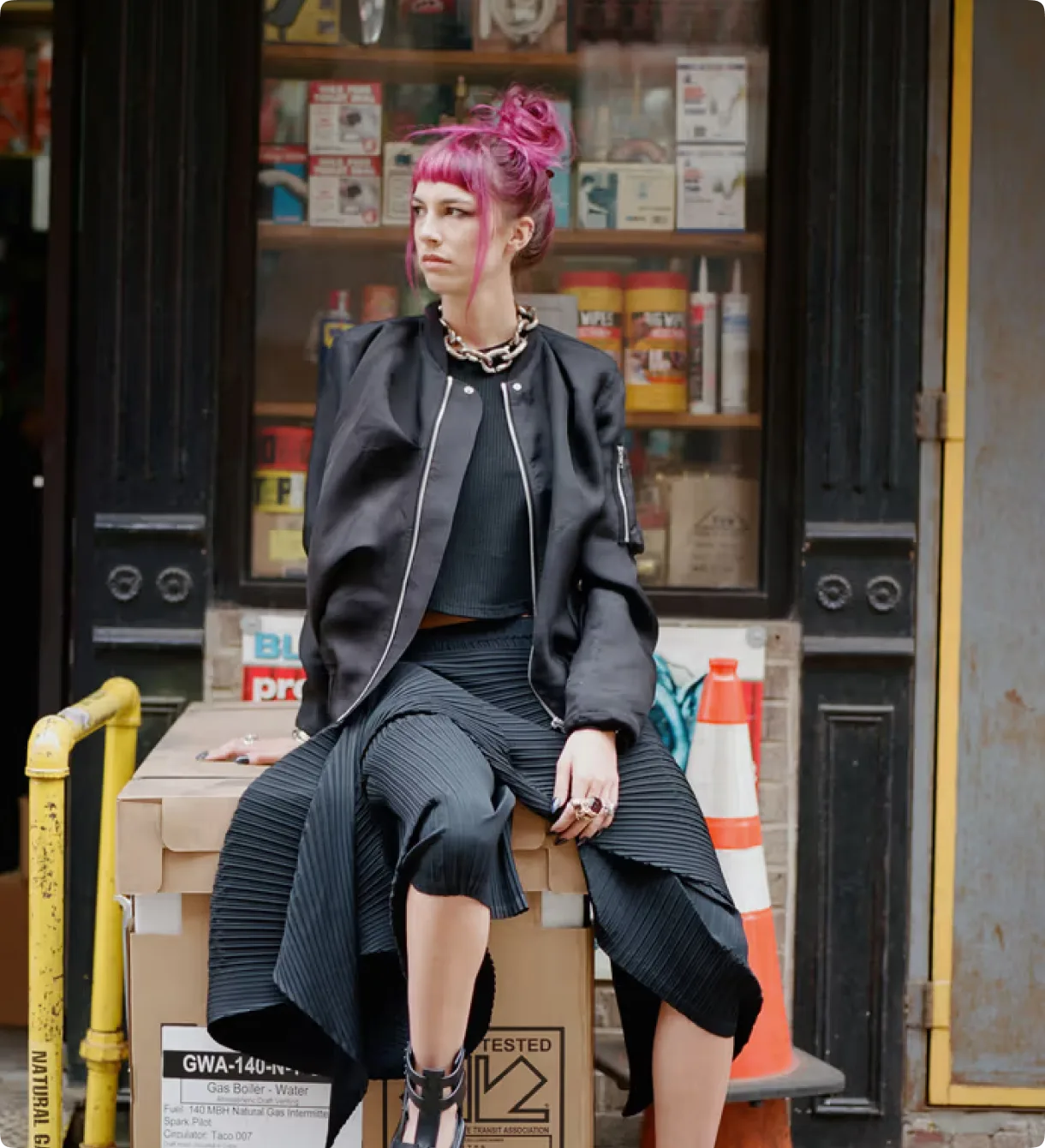 Philippa Price seated in front of a storefront